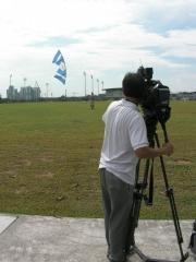 Peter with a zero-wind indoor Rev, being filmed by the MediaCorp camera man